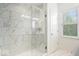 Bright glass-door shower featuring modern tiling, rain shower head, and convenient shelving at 1655 Avondale Dr, Westfield, IN 46074