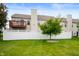 Backyard featuring a wooden deck, white fencing, green trees, and open grass at 16956 Fulton Pl, Westfield, IN 46074