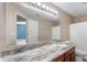 A bathroom featuring a vanity with granite counters, and a large mirror at 16956 Fulton Pl, Westfield, IN 46074