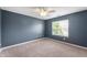 Carpeted bedroom with blue walls, a ceiling fan, and a window view of the outdoors at 16956 Fulton Pl, Westfield, IN 46074