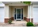 Inviting front porch with blue trimmed door and brick accents, adding a pop of color at 16956 Fulton Pl, Westfield, IN 46074