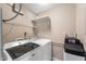 A laundry room with front loading machines and utility shelving at 16956 Fulton Pl, Westfield, IN 46074