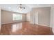 Bright living room with wood floors, natural light from a large window, and a ceiling fan at 16956 Fulton Pl, Westfield, IN 46074