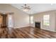 Inviting living room featuring hardwood floors, fireplace, and multiple windows for bright, natural light at 16956 Fulton Pl, Westfield, IN 46074
