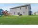 Large backyard with a well-maintained lawn and a playset for outdoor fun at 1715 Foudray S Cir, Avon, IN 46123