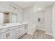 Bathroom with a double sink vanity, soaking tub, and a hardwood style floor at 1715 Foudray S Cir, Avon, IN 46123