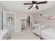 Bright bedroom with crib, decor shelves, and an open closet at 1715 Foudray S Cir, Avon, IN 46123