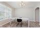 Minimalist dining room with a contemporary table, neutral walls, a window, and wood-look flooring at 1715 Foudray S Cir, Avon, IN 46123