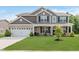 Beautiful two-story home featuring a well-maintained lawn, inviting front porch, and attached two-car garage at 1715 Foudray S Cir, Avon, IN 46123