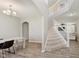 Open foyer with staircase, chandelier, and wood-look flooring, offering a welcoming entrance to the home at 1715 Foudray S Cir, Avon, IN 46123