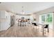 Open kitchen and dining area with white cabinets, stainless steel appliances, and hardwood floors at 1715 Foudray S Cir, Avon, IN 46123