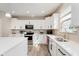 Bright kitchen featuring white cabinets, stainless steel appliances, and quartz countertops at 1715 Foudray S Cir, Avon, IN 46123