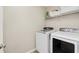 Bright laundry room featuring a Samsung washer and dryer with overhead storage at 1715 Foudray S Cir, Avon, IN 46123