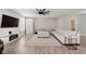 Spacious living room with a large sectional sofa, modern decor, and wood flooring at 1715 Foudray S Cir, Avon, IN 46123