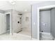 Contemporary bathroom featuring a walk-in shower with mosaic tile flooring and laundry hookups at 1723 Fletcher Ave, Indianapolis, IN 46203