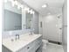 Bathroom featuring double vanity with white countertop, a white tiled walk in shower, and modern fixtures at 1723 Fletcher Ave, Indianapolis, IN 46203