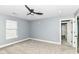 Unfurnished bedroom with carpet, a modern ceiling fan, and an attached bathroom at 1723 Fletcher Ave, Indianapolis, IN 46203