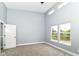 Bright bedroom with high ceilings, plush carpeting, and large windows that offer a scenic outdoor view at 1723 Fletcher Ave, Indianapolis, IN 46203