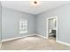 A bedroom with carpet, one window, and an ensuite bathroom at 1723 Fletcher Ave, Indianapolis, IN 46203
