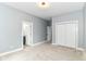 This bedroom features neutral carpet, a double door closet, and an attached bath at 1723 Fletcher Ave, Indianapolis, IN 46203