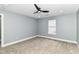 This bedroom features neutral walls and carpet, and a modern ceiling fan at 1723 Fletcher Ave, Indianapolis, IN 46203