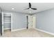 This bedroom features a ceiling fan, carpet, and a walk in closet at 1723 Fletcher Ave, Indianapolis, IN 46203