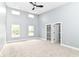 Spacious primary bedroom featuring a ceiling fan, large windows, and walk-in closets at 1723 Fletcher Ave, Indianapolis, IN 46203