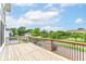 Spacious wooden deck offering scenic neighborhood views under a bright blue sky with scattered clouds at 1723 Fletcher Ave, Indianapolis, IN 46203