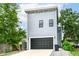 Modern two-story home with a gray exterior, a black garage door, and well-maintained landscaping at 1723 Fletcher Ave, Indianapolis, IN 46203