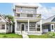 Inviting two-story home with a gray exterior, balcony, and well-maintained front yard at 1723 Fletcher Ave, Indianapolis, IN 46203