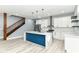 Bright kitchen with white cabinets, stainless steel appliances, and vibrant blue island at 1723 Fletcher Ave, Indianapolis, IN 46203