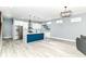 Modern kitchen with stainless steel appliances, bright white cabinets, and blue center island at 1723 Fletcher Ave, Indianapolis, IN 46203
