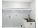 Laundry room with stainless steel sink, gray walls, and white shelving at 1723 Fletcher Ave, Indianapolis, IN 46203