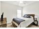 Bright bedroom with a bed featuring blue patterned bedding and a dresser, illuminated by natural light at 17319 Henslow Dr, Westfield, IN 46074