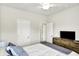 Cozy bedroom featuring a bed with white comforter, blue accents, and a wooden dresser with a TV at 17319 Henslow Dr, Westfield, IN 46074