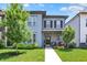 Charming two-story home featuring a well-manicured lawn, covered porch with seating and stylish gray siding at 17319 Henslow Dr, Westfield, IN 46074