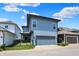 Exterior view of a modern two-story home with a two-car garage and putting green at 17319 Henslow Dr, Westfield, IN 46074