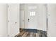 Bright hallway featuring wood floors, a welcome mat, and a front door with window panels at 17319 Henslow Dr, Westfield, IN 46074