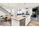 Well-lit kitchen features a large island with seating, stainless steel appliances, and an adjacent dining area at 17319 Henslow Dr, Westfield, IN 46074