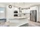 Bright kitchen featuring stainless steel appliances, a granite island, and ample cabinet space for modern convenience at 17319 Henslow Dr, Westfield, IN 46074