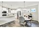 Bright kitchen and dining area featuring white cabinets, stainless steel appliances, and pendant lighting at 17319 Henslow Dr, Westfield, IN 46074