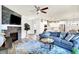 Inviting living room featuring a stone fireplace, comfortable seating, and an open layout to the modern kitchen at 17319 Henslow Dr, Westfield, IN 46074