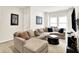 Comfortable living room with large sectional sofa, neutral tones, and multiple windows offering natural light at 17319 Henslow Dr, Westfield, IN 46074