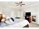 Large main bedroom with a ceiling fan, TV, and stylish decor elements for a relaxing retreat at 17319 Henslow Dr, Westfield, IN 46074
