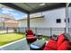 Covered patio area furnished with comfortable seating and a view of the putting green at 17319 Henslow Dr, Westfield, IN 46074