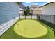 Backyard putting green framed with black fencing, creating a private recreational space at 17319 Henslow Dr, Westfield, IN 46074