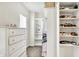 Organized walk-in closet with white shelving, drawers, and ample space for shoes and clothing at 17319 Henslow Dr, Westfield, IN 46074
