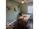 Dining room boasts decorative geese, a modern light fixture, a wood table, and a large window for natural light at 1820 Martin St, Indianapolis, IN 46237