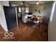 Open-concept dining area with wood floors, a modern ceiling fan, natural light, and barstool seating at 1820 Martin St, Indianapolis, IN 46237