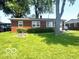 Charming brick ranch home featuring a well-manicured lawn and mature shade trees at 1820 Martin St, Indianapolis, IN 46237